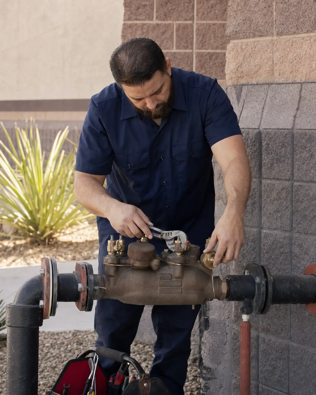 Plumber replacing a valve on a commercial backflow prevention assembly
